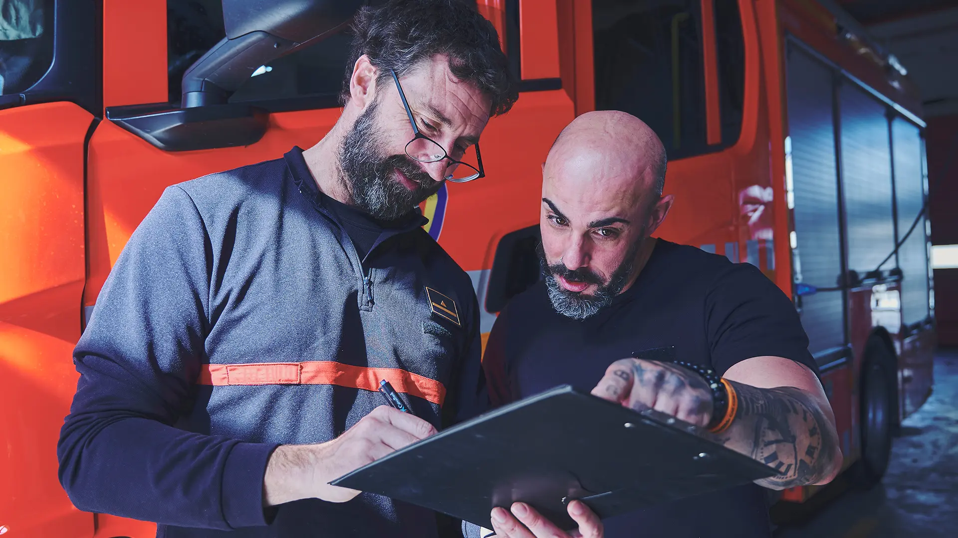 Image of emergency responders in front of a firetruck