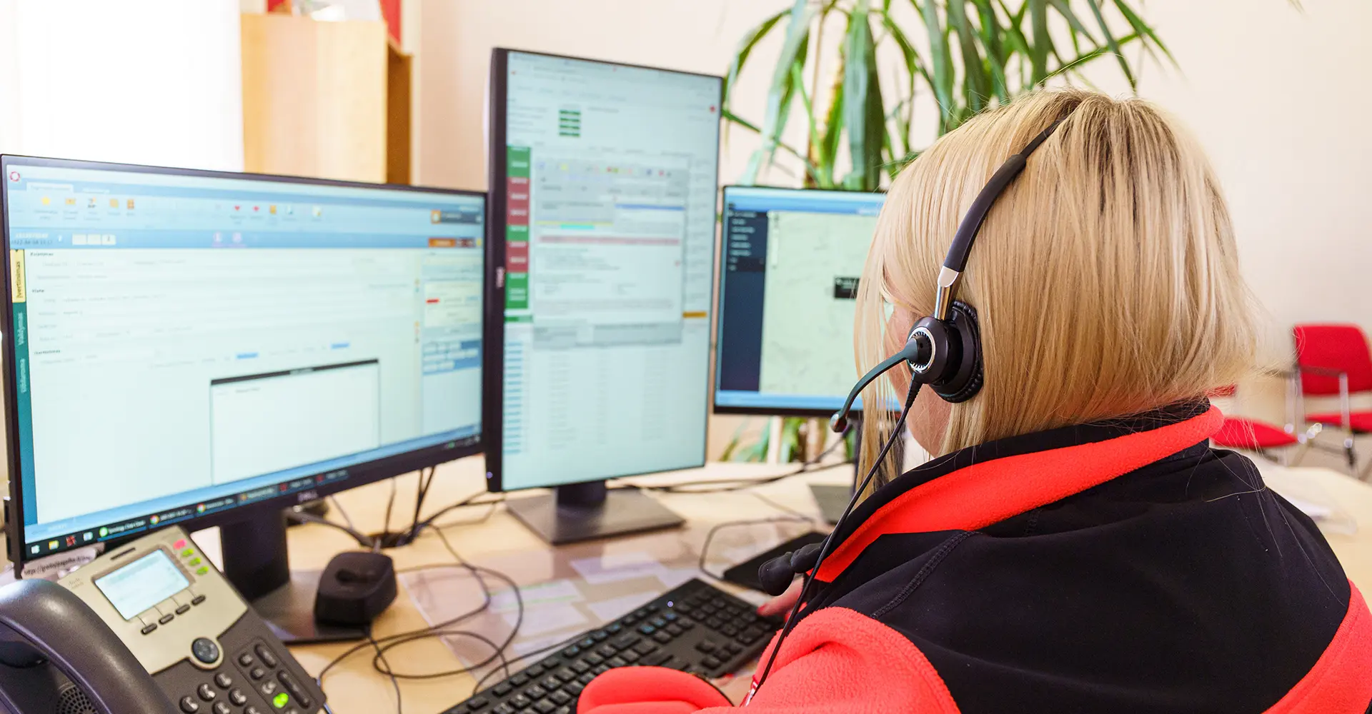 Image of emergency response personnel in a high-tech command center, showcasing advanced crisis coordination and technology integration.